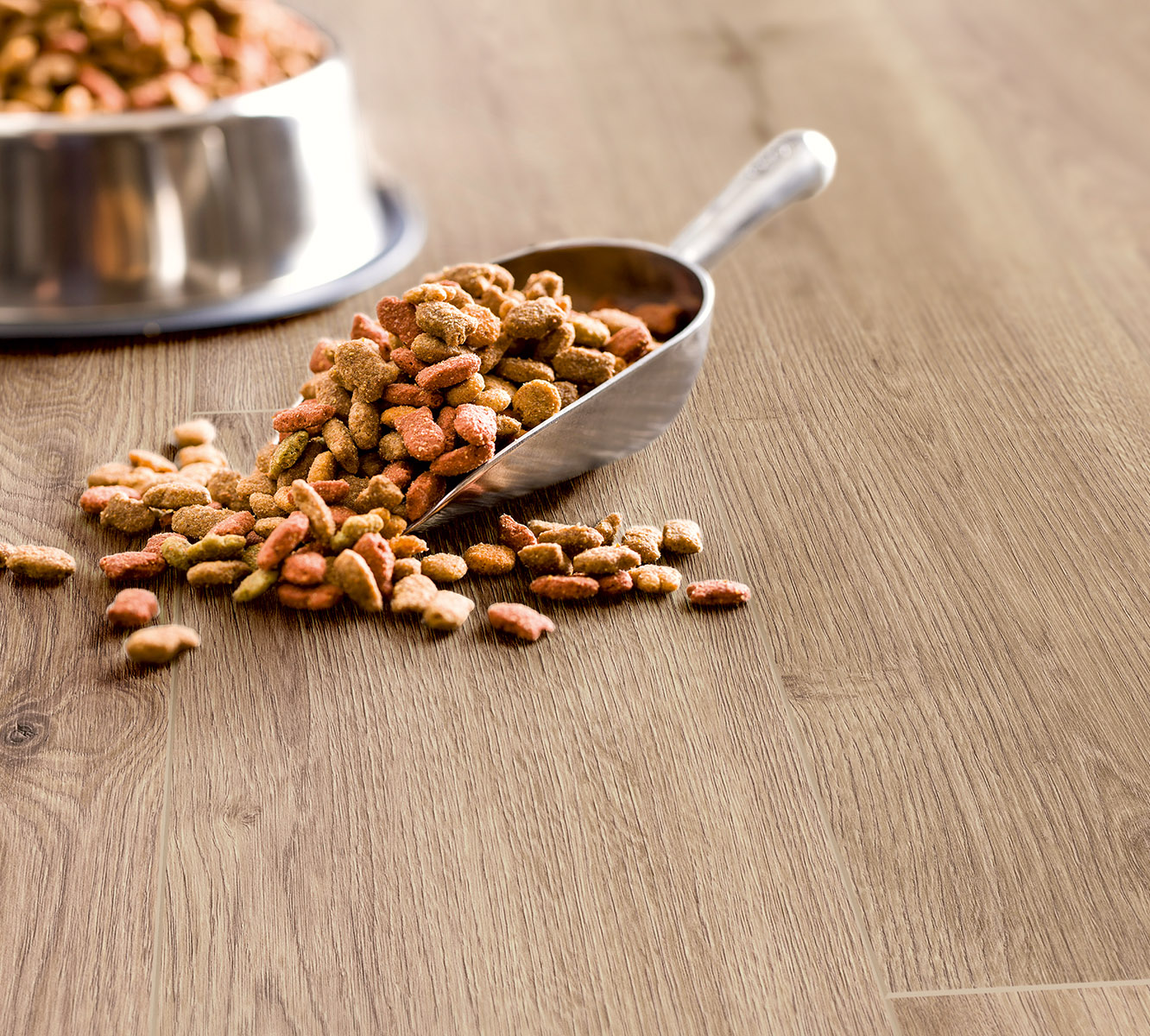 Pet-friendly oak flooring – K501 Sand River Oak with animal food and scoop highlighting real-life durability