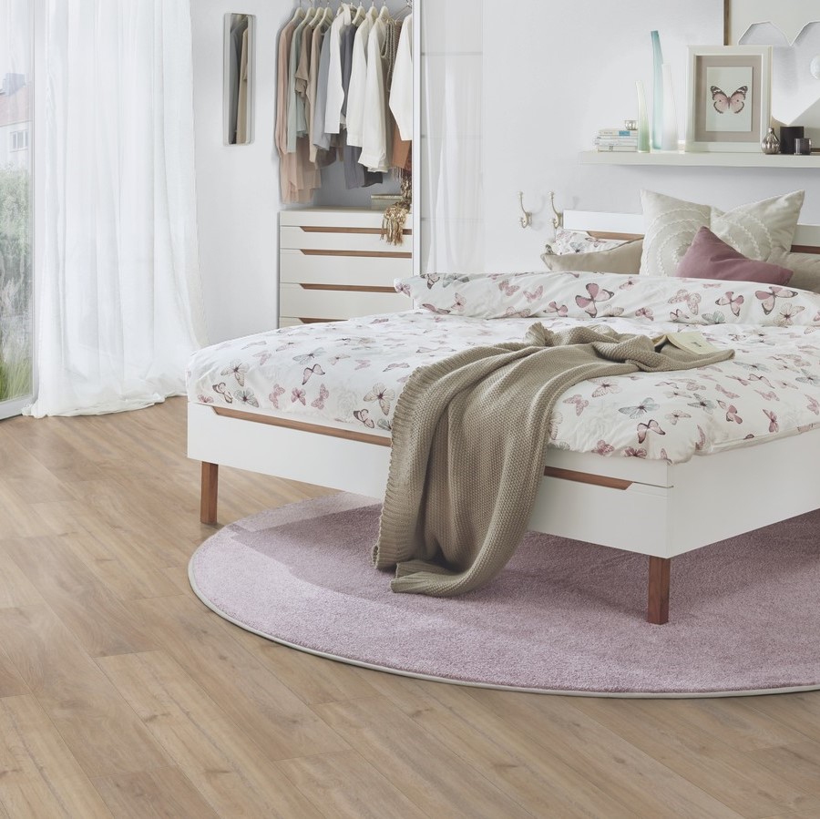 Khaki Oak laminate flooring in cozy bedroom with soft pink tones – natural warmth and elegant wood character