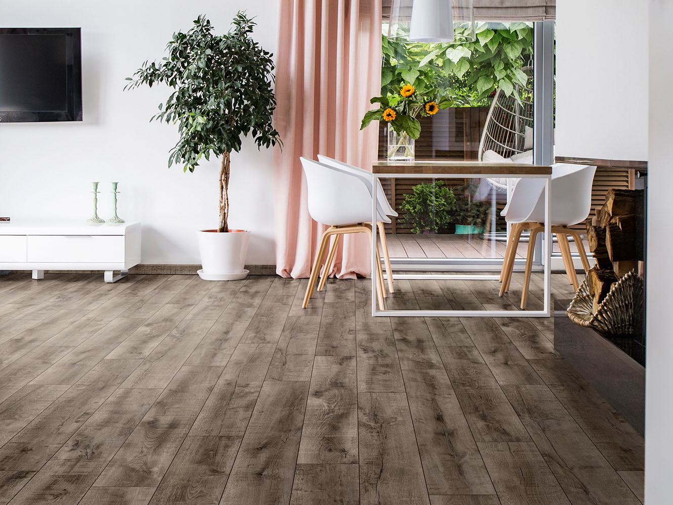 Antique Volcano Oak laminate flooring installed in a cozy living room with dining table and chairs, highlighting vintage contrast and natural tones