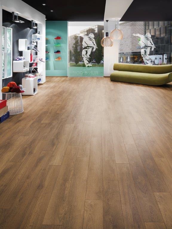A living room with Laminate Flooring Harlech Oak and furniture.