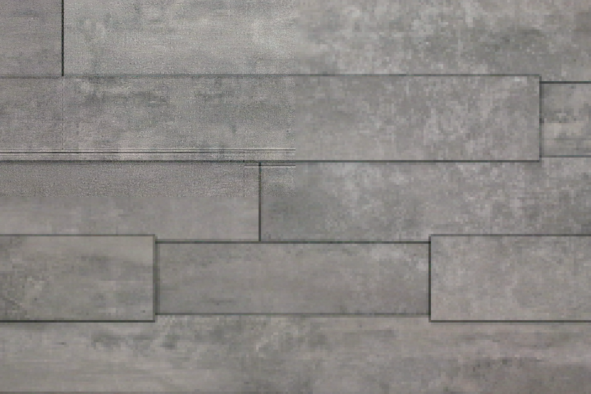K035 is a grey chameleon wall panel with light and dark accents, reminiscent of concrete, bringing a solid and industrial feel.