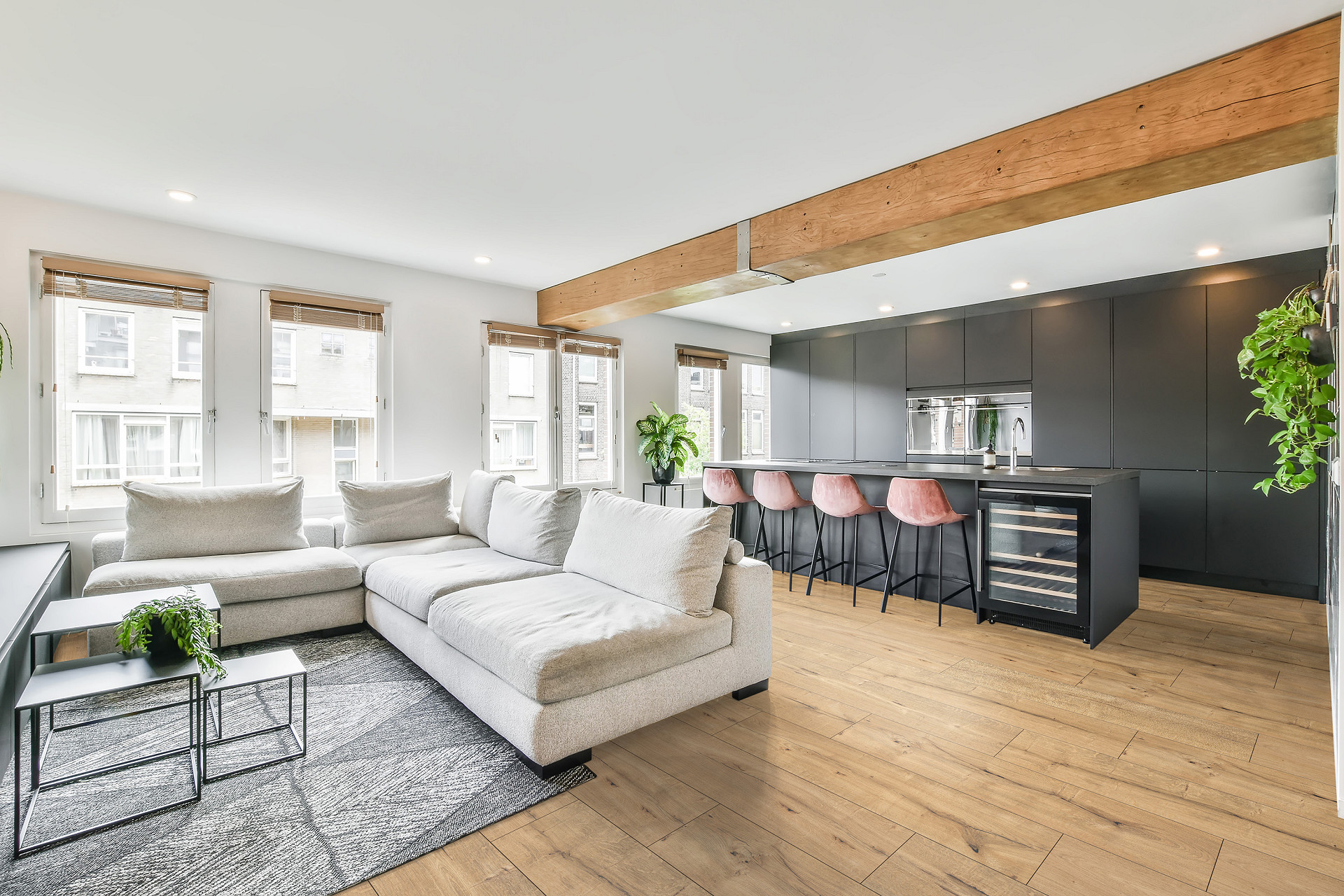 SPC flooring Nutmeg from KronoOriginal showing its wider boards in a beautifull spacious living room.