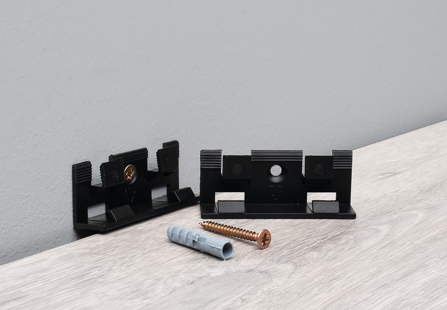 Mounting clips for MDF or PVC skirting boards. Cables can be routed behind them to remain hidden.