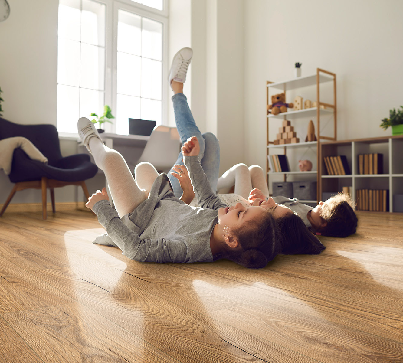 Kids playing on K476 Inca Carpenter Oak laminate – safe, comfortable, and antibacterial flooring for family homes