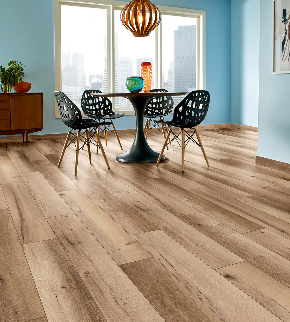 K507 Hazel Range Oak laminate flooring  in a stylish, fresh dining room interior