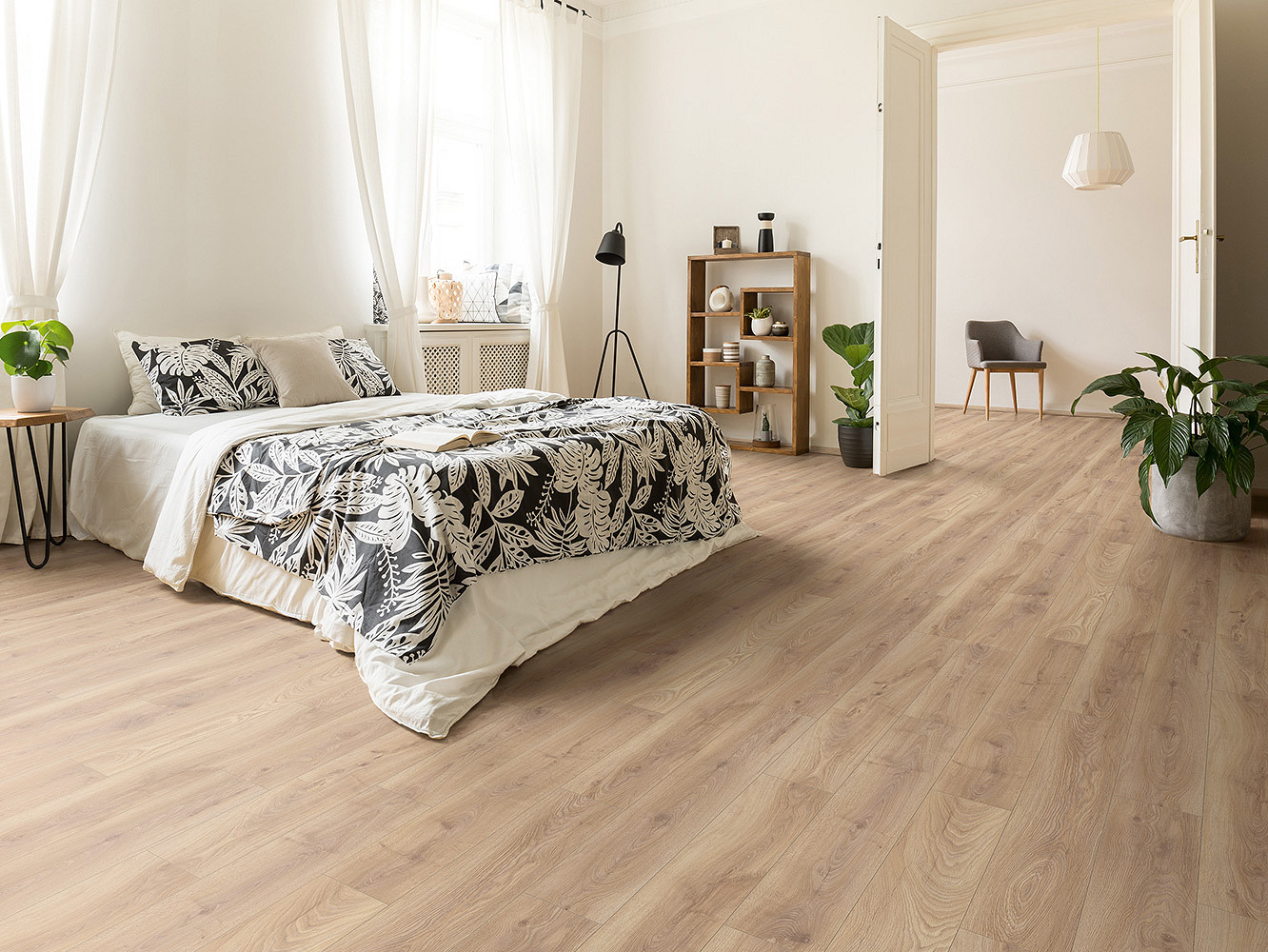 Cozy bedroom with Biscotti Oak laminate flooring, combining warm oak décor with soft interior design