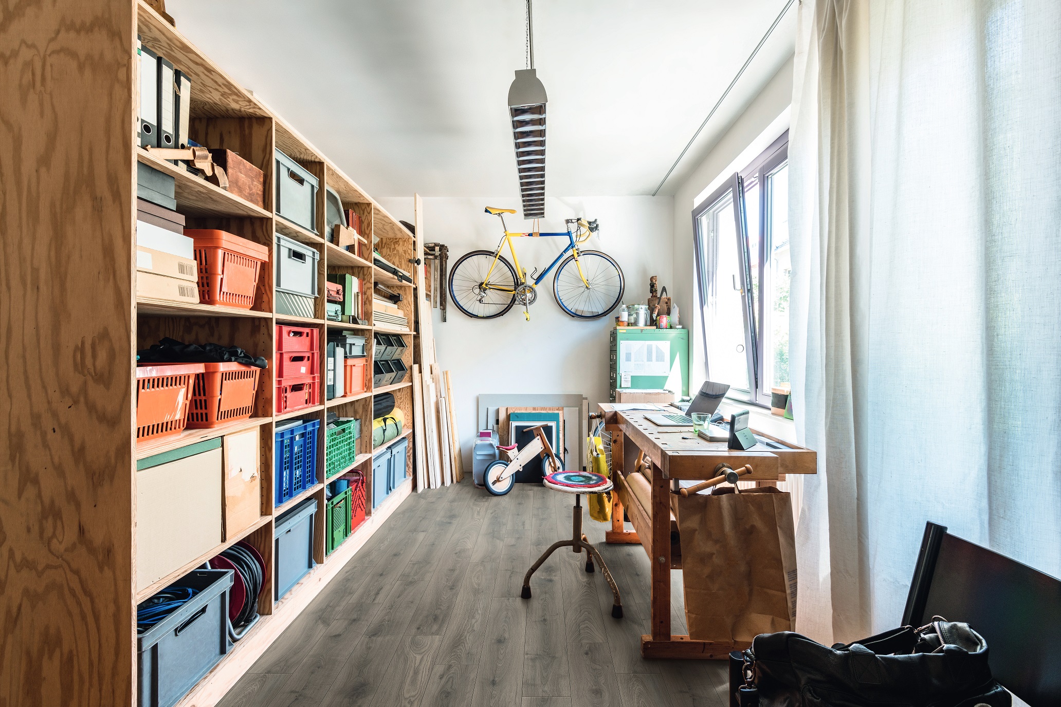Steelworks Oak laminate flooring in compact home office or utility space – grey tones matching functional and modern interior